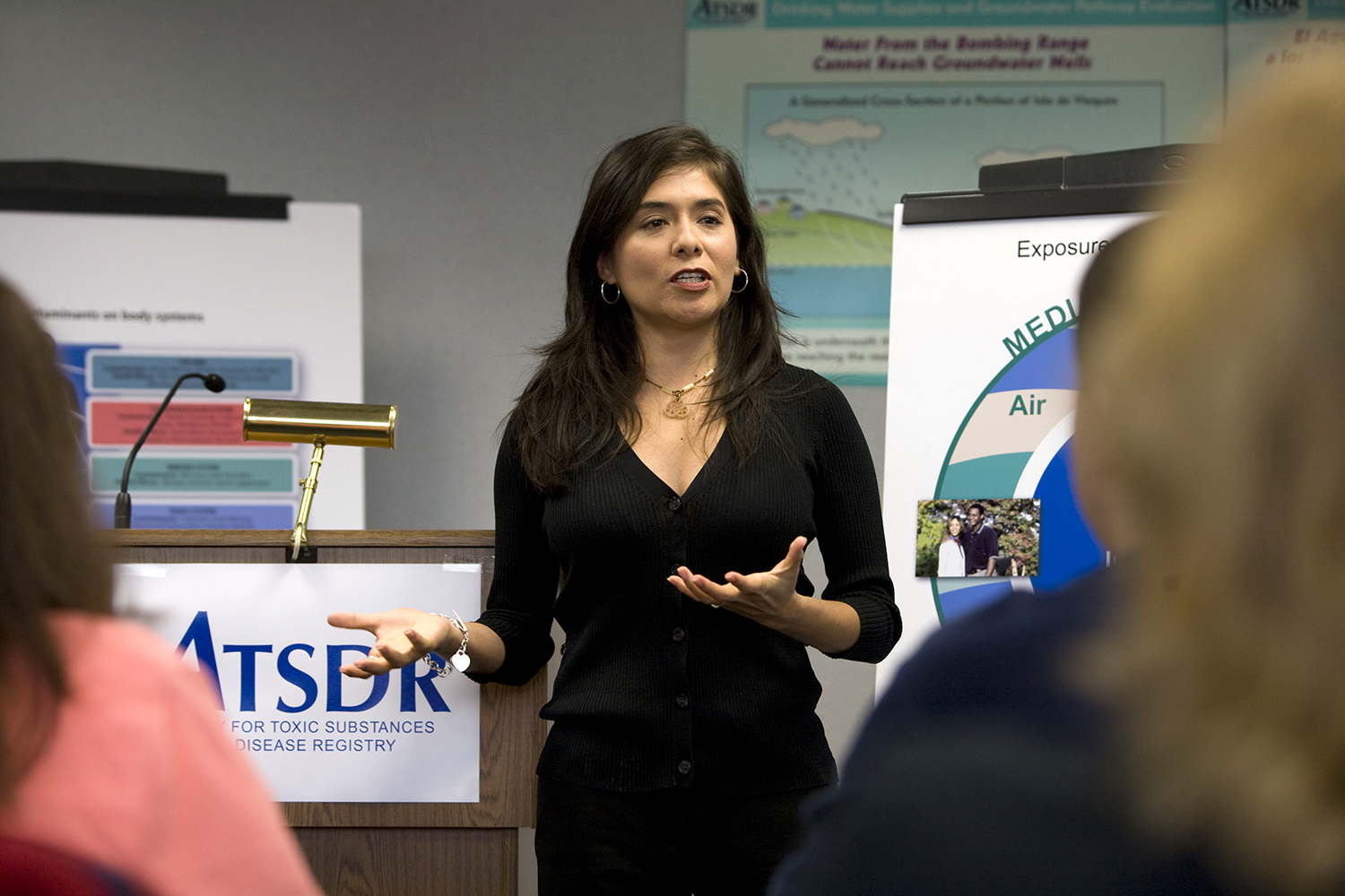 A person speaking in front of a crowd. A podium with ATSDR's logo appears in the background.