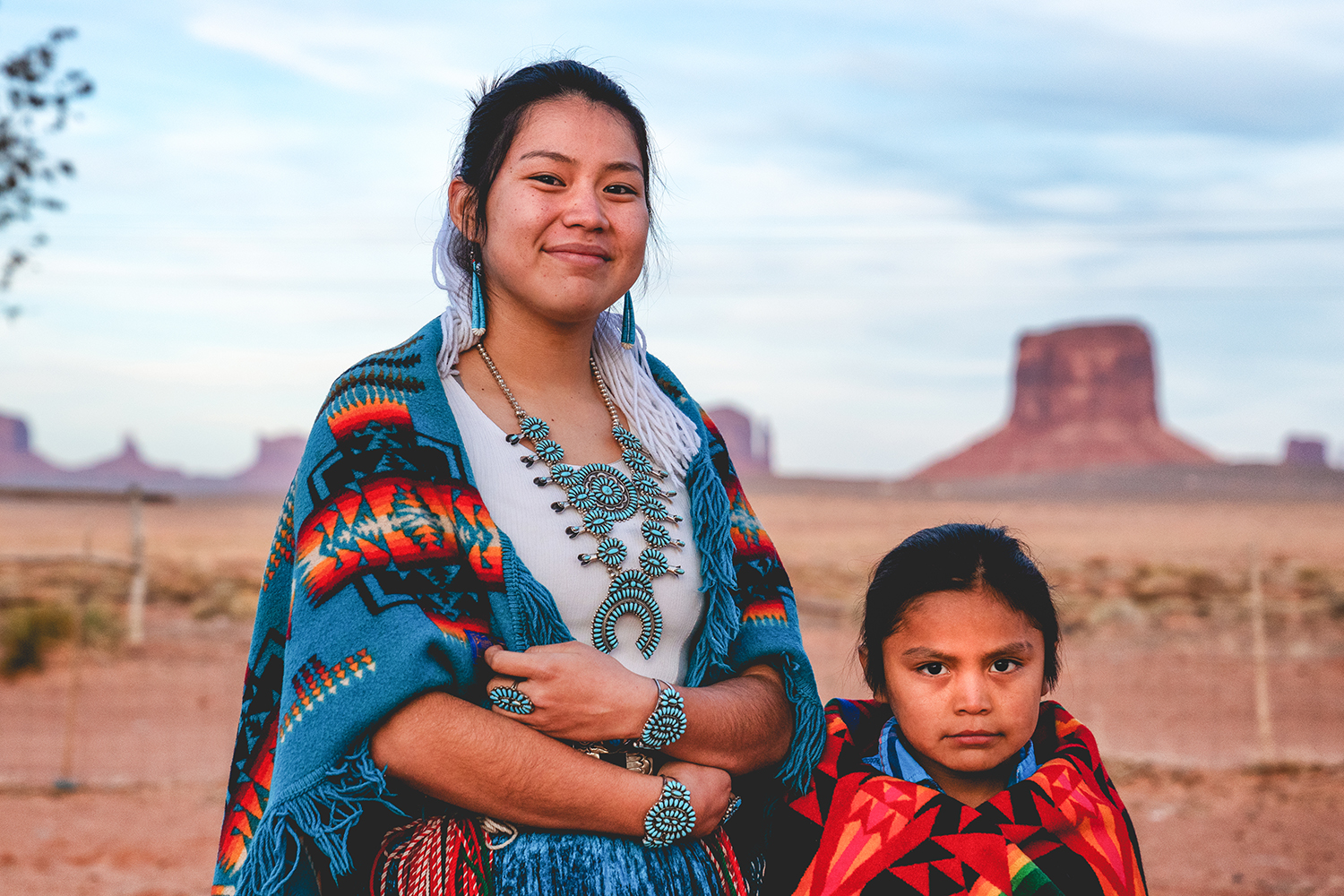 A young Navajo sister and little brother pose for photographs.