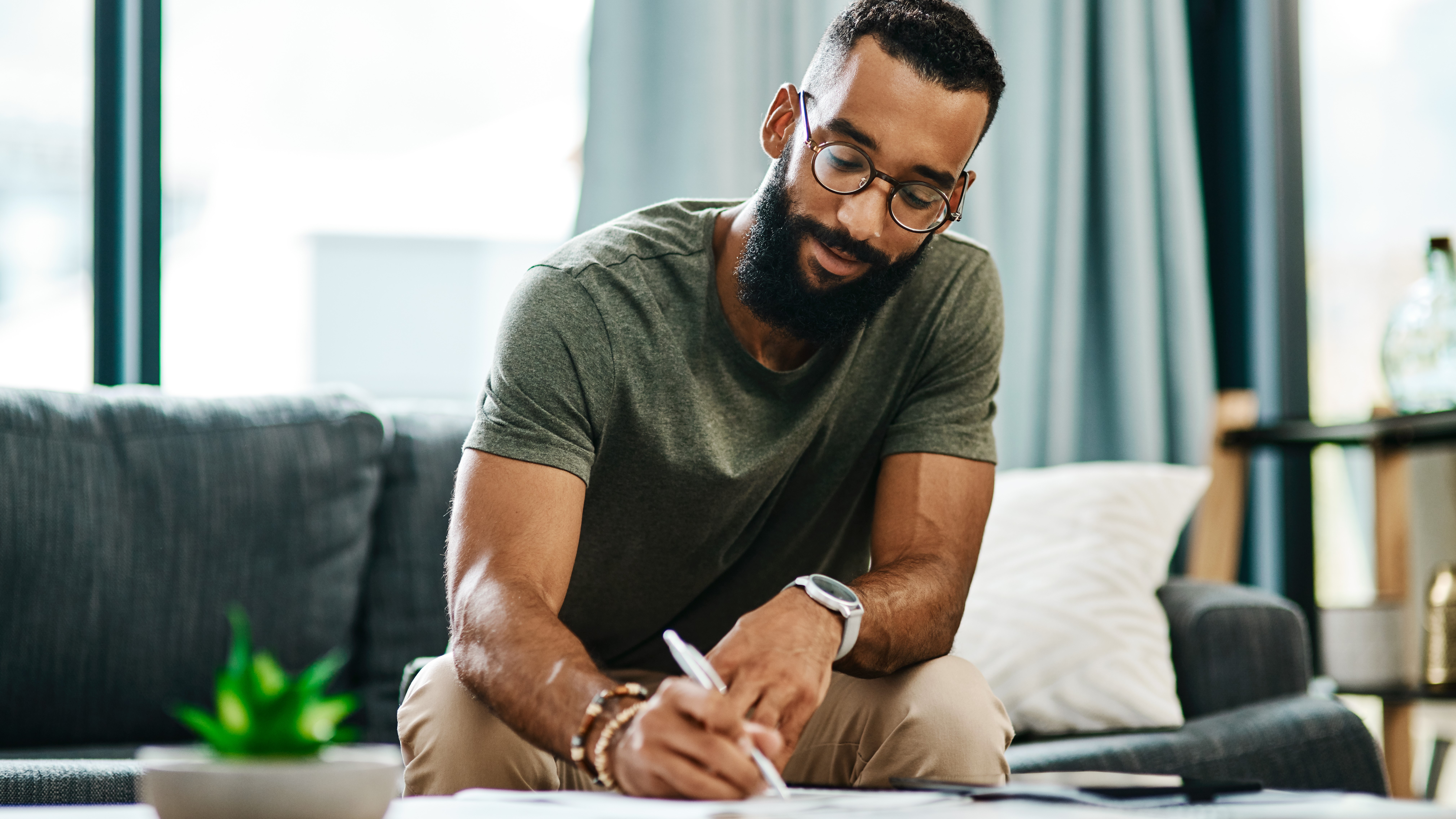 man filling a form at home