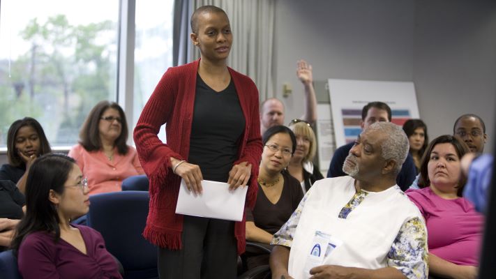 A woman giving a presentation to a group of people.