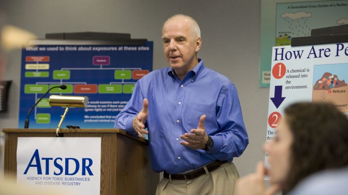 A person speaking at a podium.