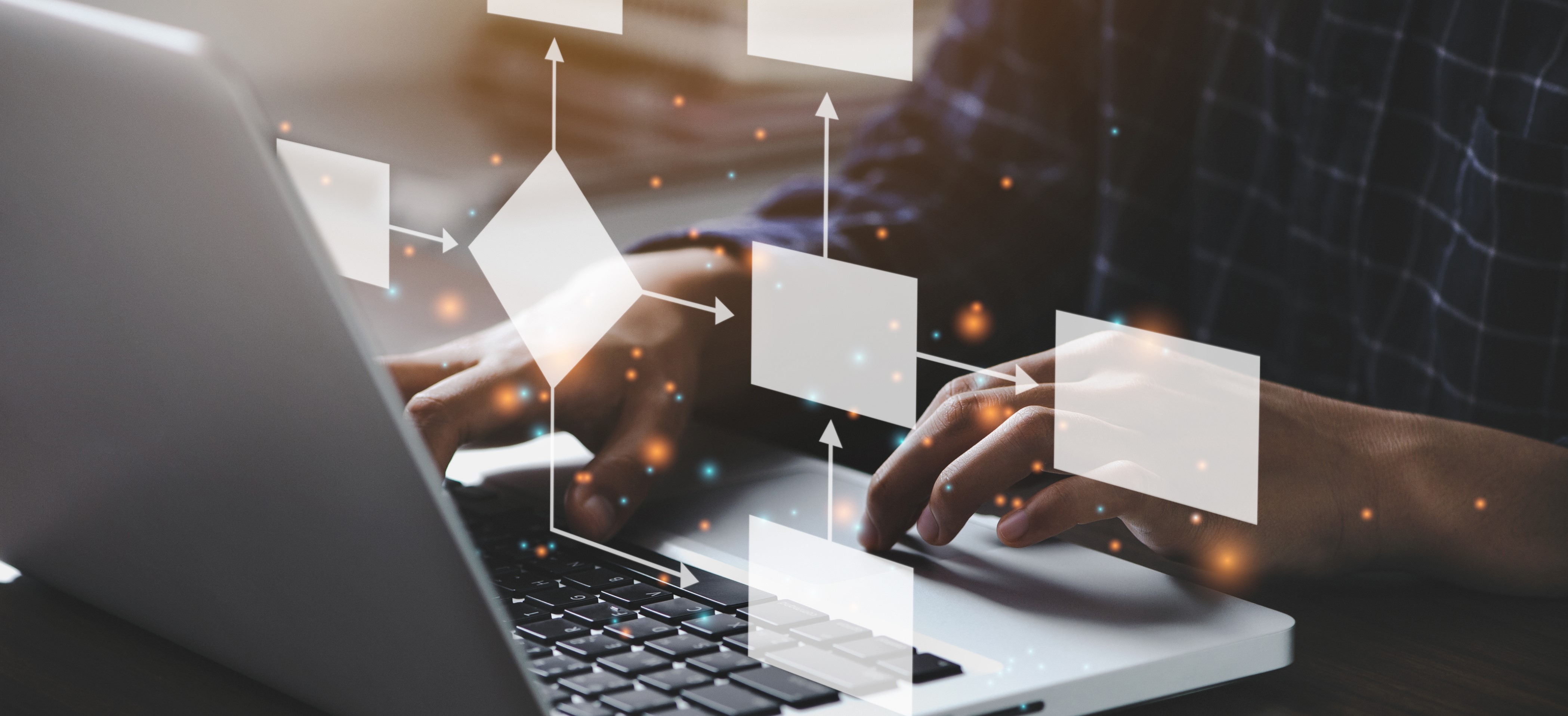 Two hands typing on a laptop and floating symbols demonstrating connections and networks.