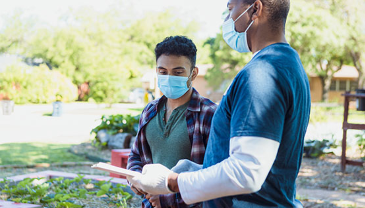 Men in masks, gardening