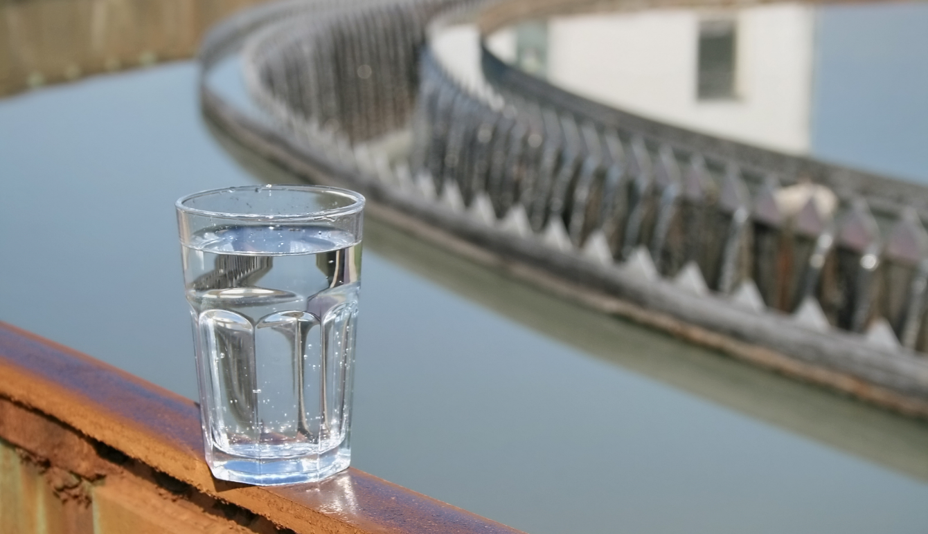 A glass of clear water on a ledge.