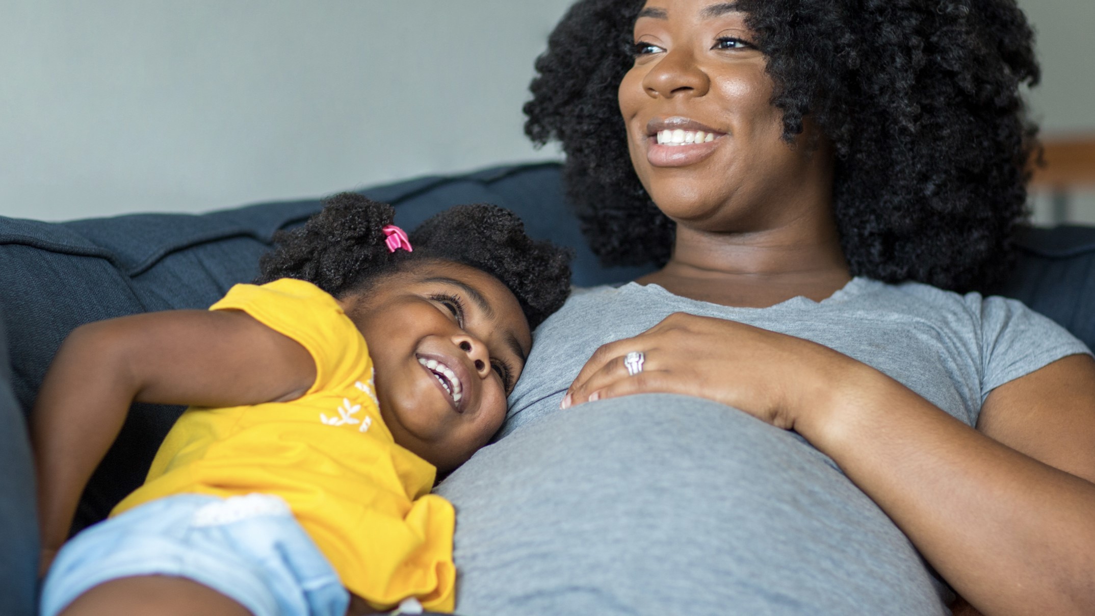 African American pregnant mother and daughter