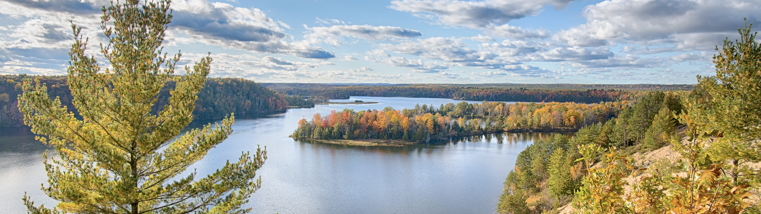 Sweeping vista of a lake and land in the fall.