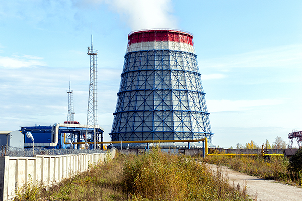 An electric power station tower in a field