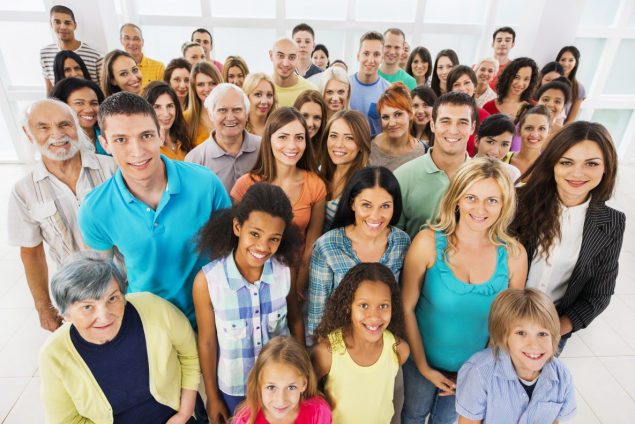 Large group of people standing and smiling at the camera