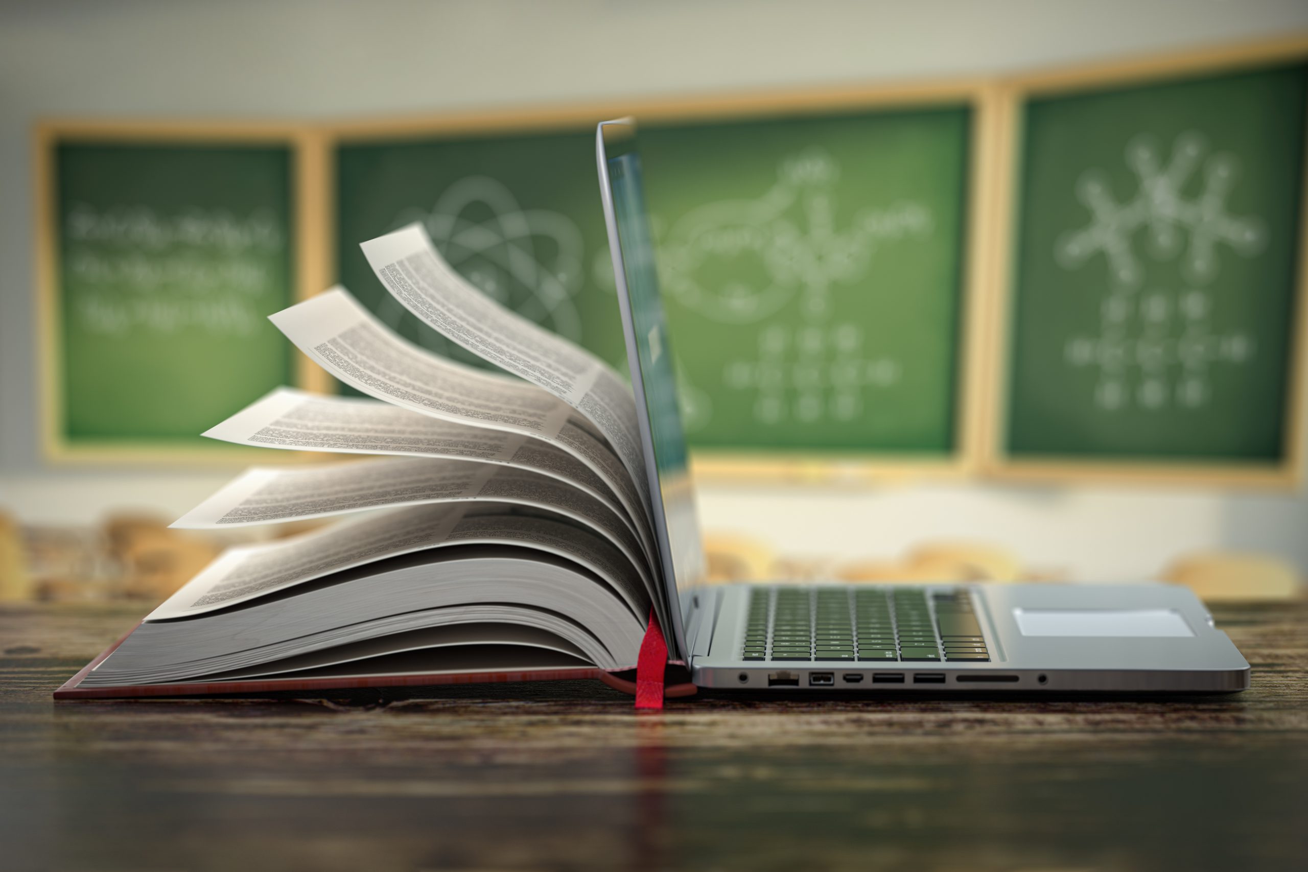 Reference book open on a table in front of a chalkboard