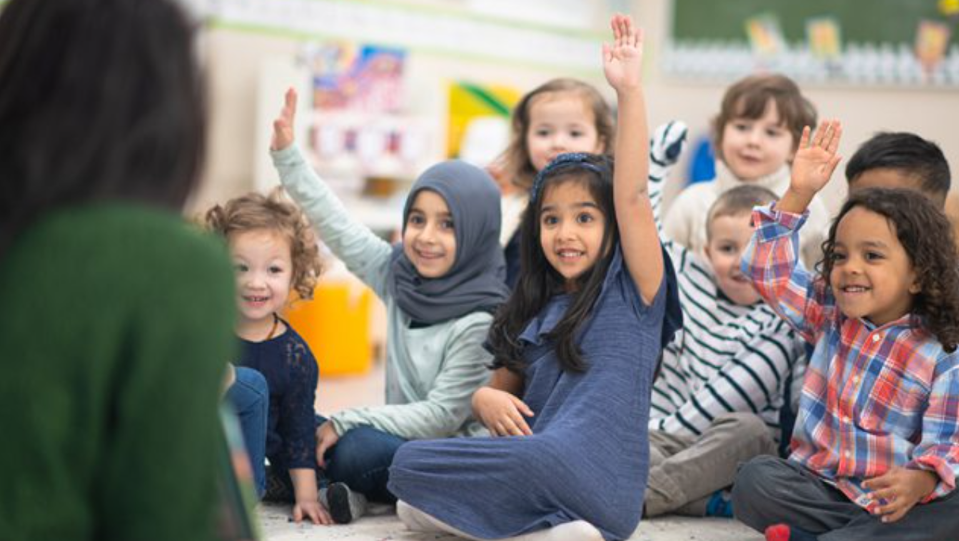 Children raising their hands.